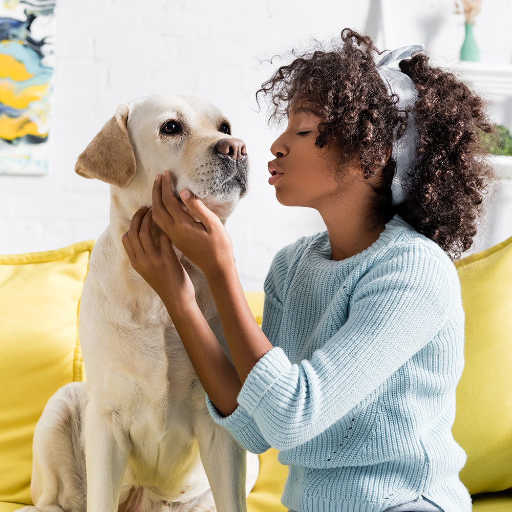 Pet parent embracing dog